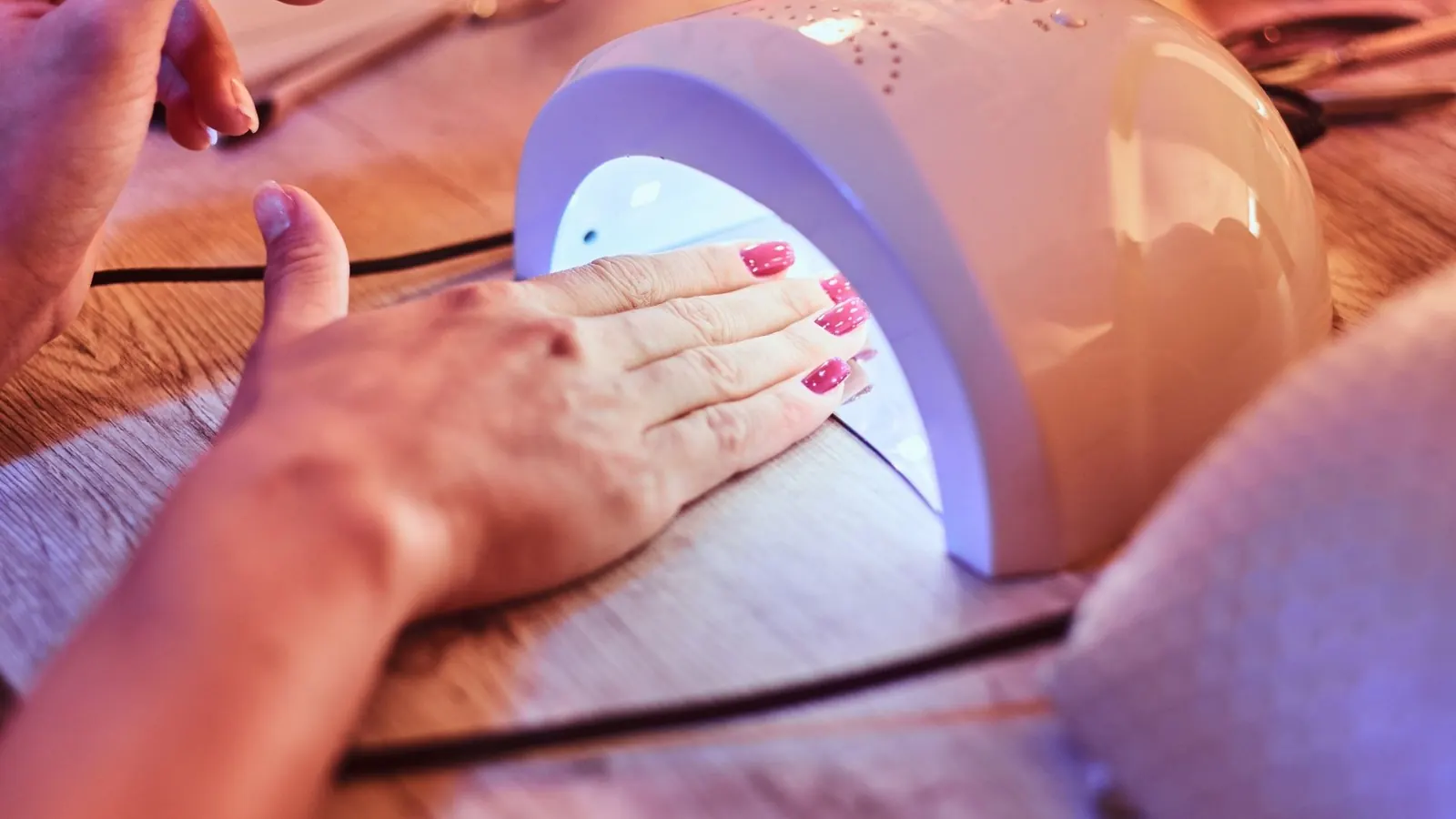 Gel nails under curing lamp in Tustin CA